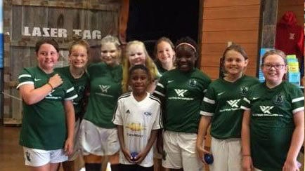 Youth soccer team in green jerseys celebrating at Kokomo Joe's